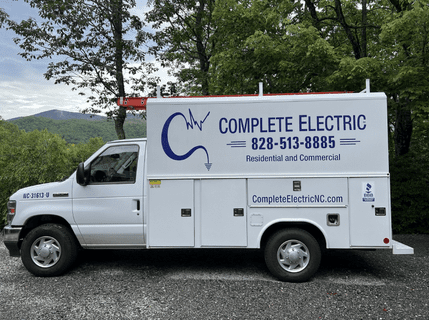 A white truck with the words " complete electric " on it.